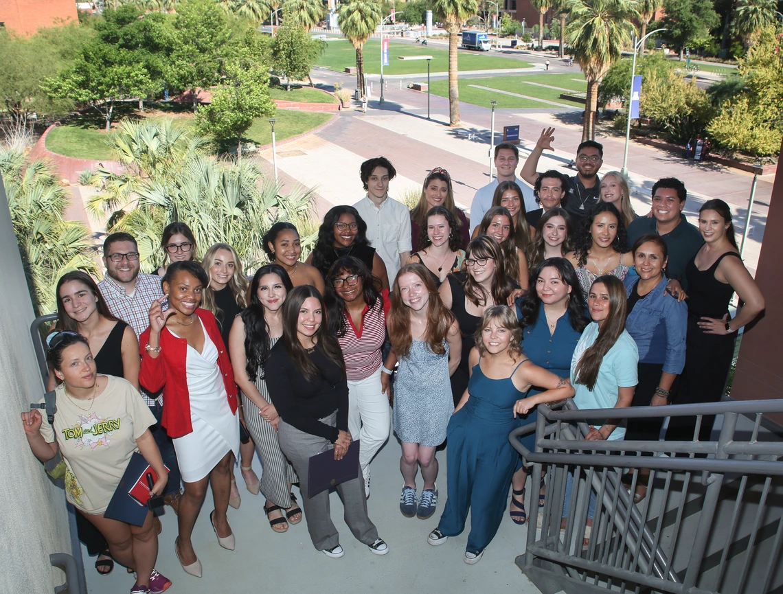 A group of students stand in the stairwell of the student union