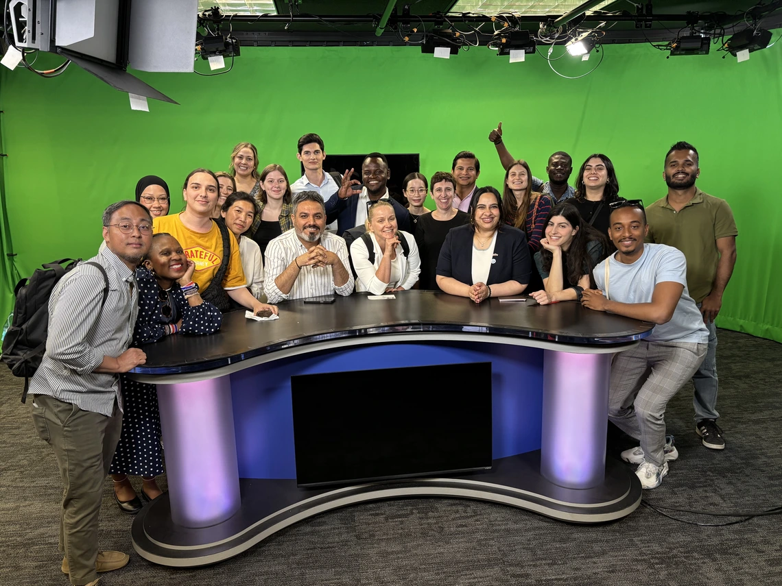 A group of journalists in a broadcast studio