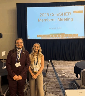 Dr. Josh Anderson and student at a research conference