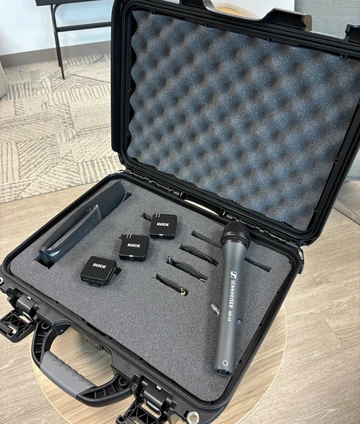 A portable case containing wireless microphones