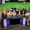 A group of journalists in a broadcast studio