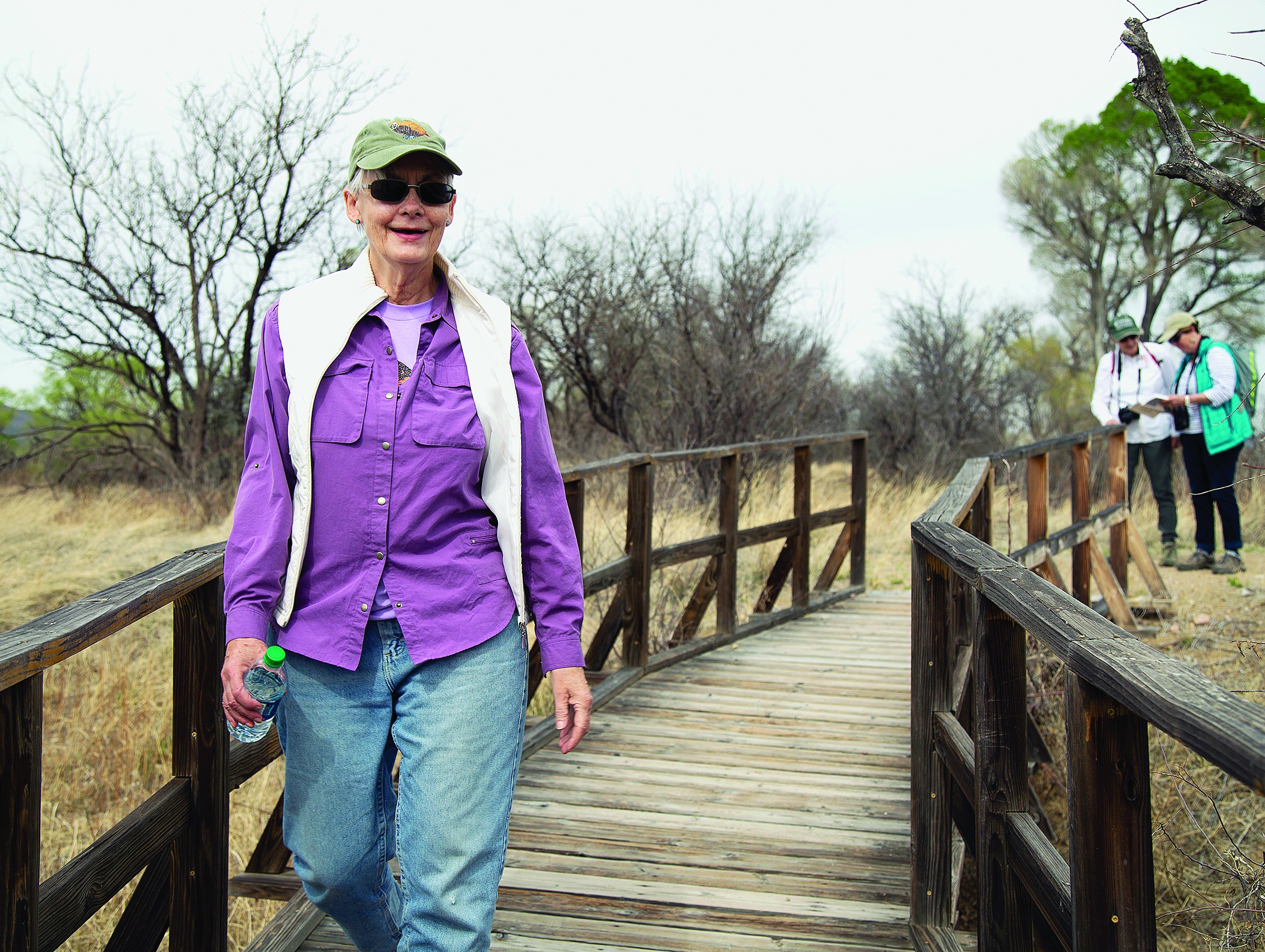 Prof. Carol Schwalbe walks on bridge at refuge.