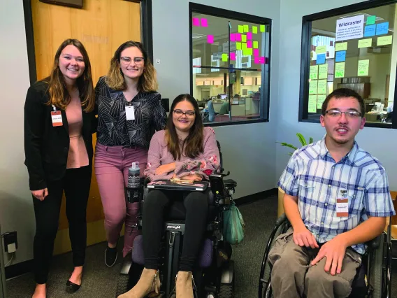 Group of students standing and in wheelchairs