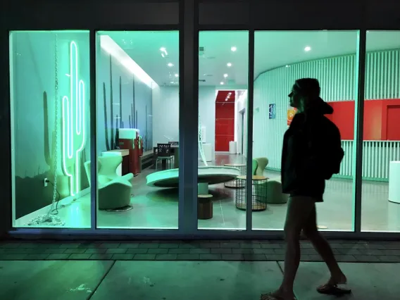 student walking in front of building