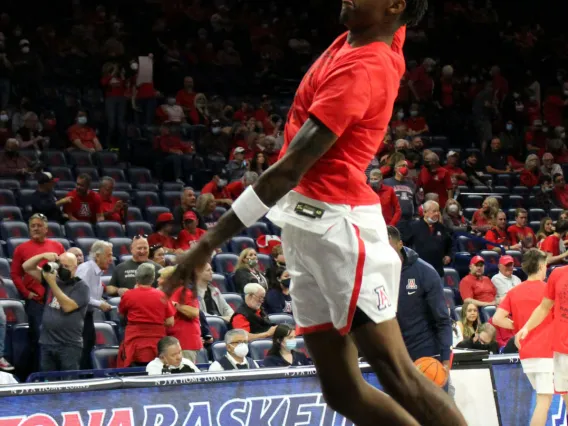 A man dunking a basketball. 