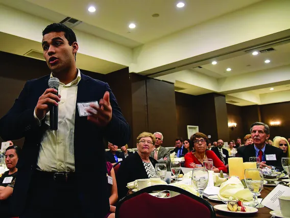 Student speaking at large gathering