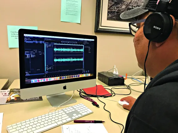 Student checks audio for a podcast.