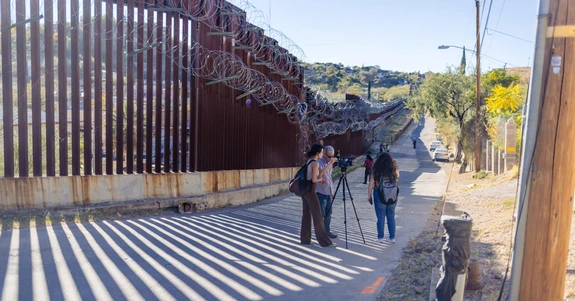 Students and professor set up camera at border wall in Nogales