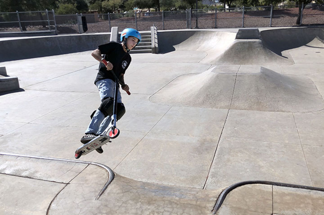 Child in skate park on scooter