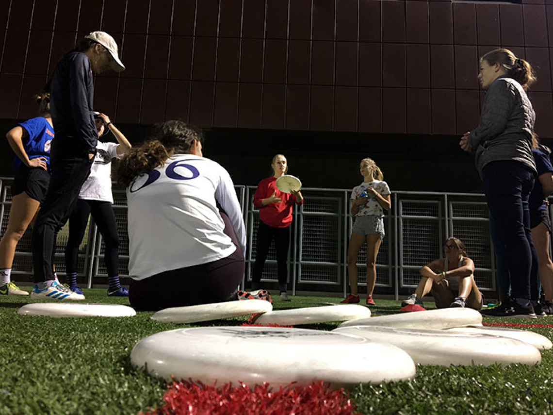 Women's ultimate frisbee team practicing